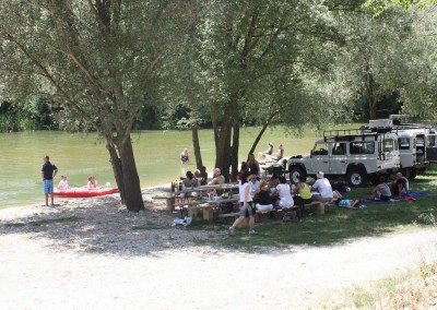 Lunch break on a meadow by the river; jeep safari excursion