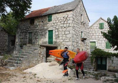 Split Adventure guides in front of stone houses in Zadvarje village